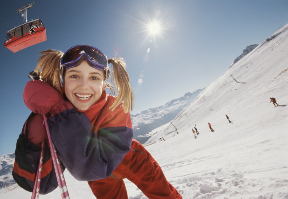 Skier smiles at the camera.