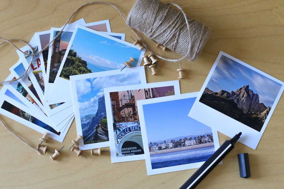 Materials for creating a world map – retro prints, square prints, string, and a marker Materials for creating a world map – retro prints, square prints, string, and a marker